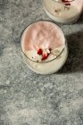 Occhiali con mousse dolce decorati con fiori sulla superficie in pietra — Foto stock