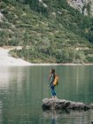 Женщина-турист на камне в озере — стоковое фото