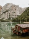 Wooden house with boats among mountains — Stock Photo