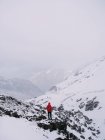 Anonymous person in snowy mountains — Stock Photo