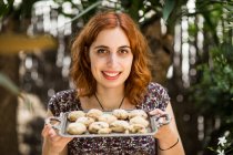 Woman with fresh cookies — Stock Photo
