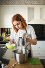 Woman cooking at home — Stock Photo