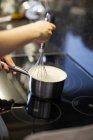 Cook whisking in pot — Stock Photo