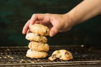 Hand putting cookies in roll — Stock Photo