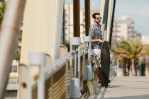 Man standing with skateboard — Stock Photo