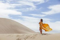 Woman in sand dunes — Stock Photo