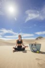 Femme pratiquant le yoga dans le désert — Photo de stock