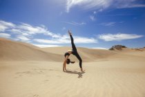 Woman stretching body in desert — Stock Photo