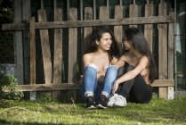 Topless lesbian couple near fence — Stock Photo