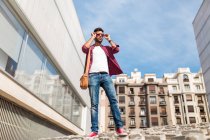 Trendy man posing in sunglasses — Stock Photo