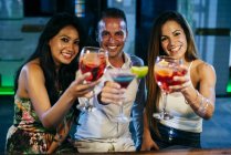 Persone che bevono cocktail e brindisi — Foto stock