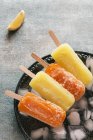 Orange and lemon popsicles — Stock Photo