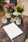 Notebook on table with flowers — Stock Photo