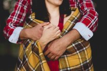 Couple embracing in plaid — Stock Photo