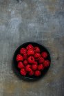 Raspberries on grunge background — Stock Photo