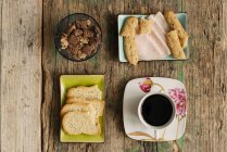 Different snacks and coffee cup — Stock Photo
