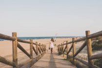 Woman in dress on wooden path — Stock Photo