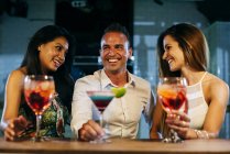 Laughing friends in bar — Stock Photo