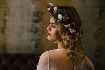 Gorgeous woman in flower-made wreath — Stock Photo