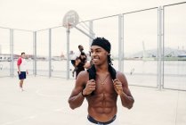 Muscular black man on basketball sports ground — Stock Photo