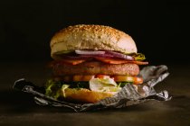 Gourmet burger on dark — Stock Photo