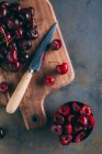Cherries in a wooden cutting board — Stock Photo