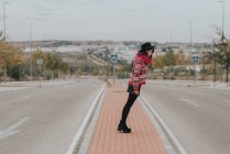 Girl bending at roadway — Stock Photo