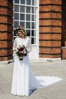 Fröhliche Braut mit Strauß — Stockfoto