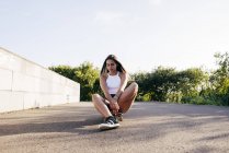 Youngster sitting on skate — Stock Photo