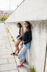 Trendy girls with skateboards — Stock Photo
