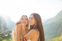 Portrait of embracing girls at highland countryside — Stock Photo