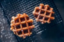 Waffles in grid with icing sugar — Stock Photo