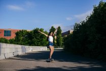Excited girl on skate in park — Stock Photo