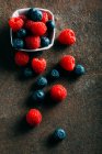 Blueberries and raspberries on a grunge — Stock Photo