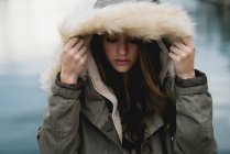 Woman covering with coat hood — Stock Photo