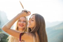 Portrait of cheerful girls posing at highland countryside — Stock Photo