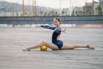 Female gymnast posing at pier — Stock Photo