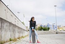 Trendy girl with skate — Stock Photo
