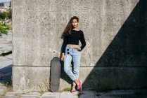 Stylish girl with skate — Stock Photo