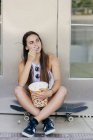 Stylish teen with popcorn — Stock Photo