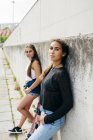 Teenager with friend posing outside — Stock Photo