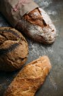 Rustic bread loaves on dark — Stock Photo