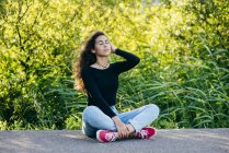 Beautiful young girl sitting on ground — Stock Photo