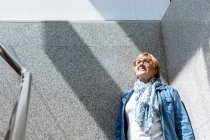 Mature woman posing in sunlight — Stock Photo