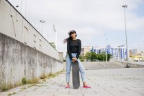 Trendy girl with skate — Stock Photo