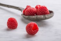 Raspberries on vintage spoon — Stock Photo