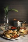 Roasted chicken served in the table — Stock Photo