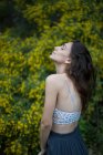 Beautiful girl posing sensually in forest — Stock Photo
