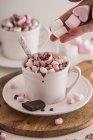 Woman hand with cup of hot chocolate — Stock Photo