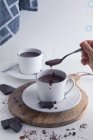 Womman hand eating hot chocolate — Stock Photo